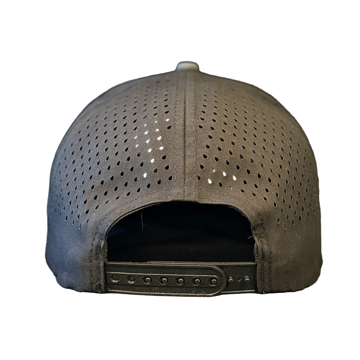 The back view of a gray perforated baseball cap with an adjustable hook-and-loop strap, resting on a textured gray surface.