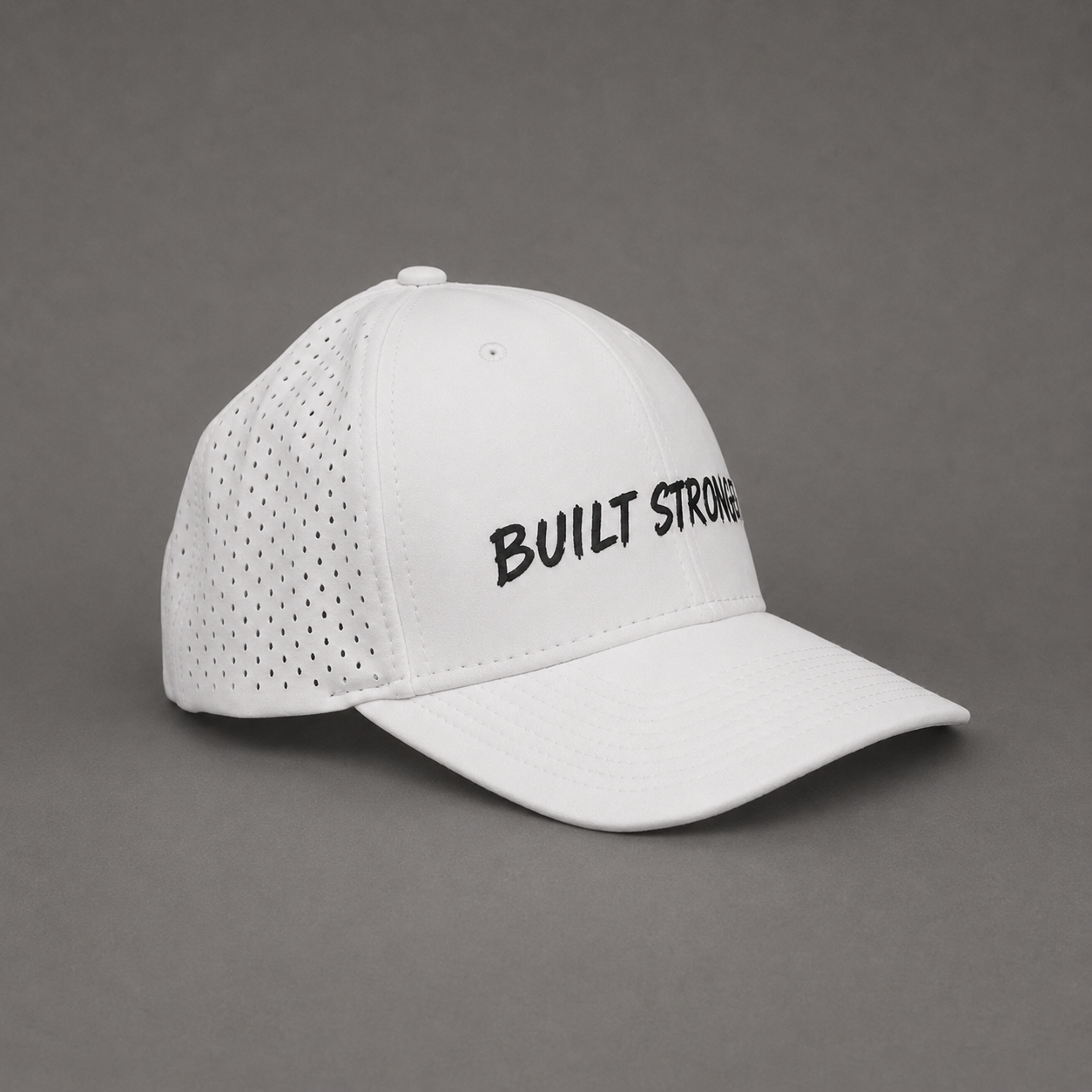 A white structured baseball cap with perforated back panels and the words 'BUILT STRONG' printed in black on the front, set against a solid gray background.