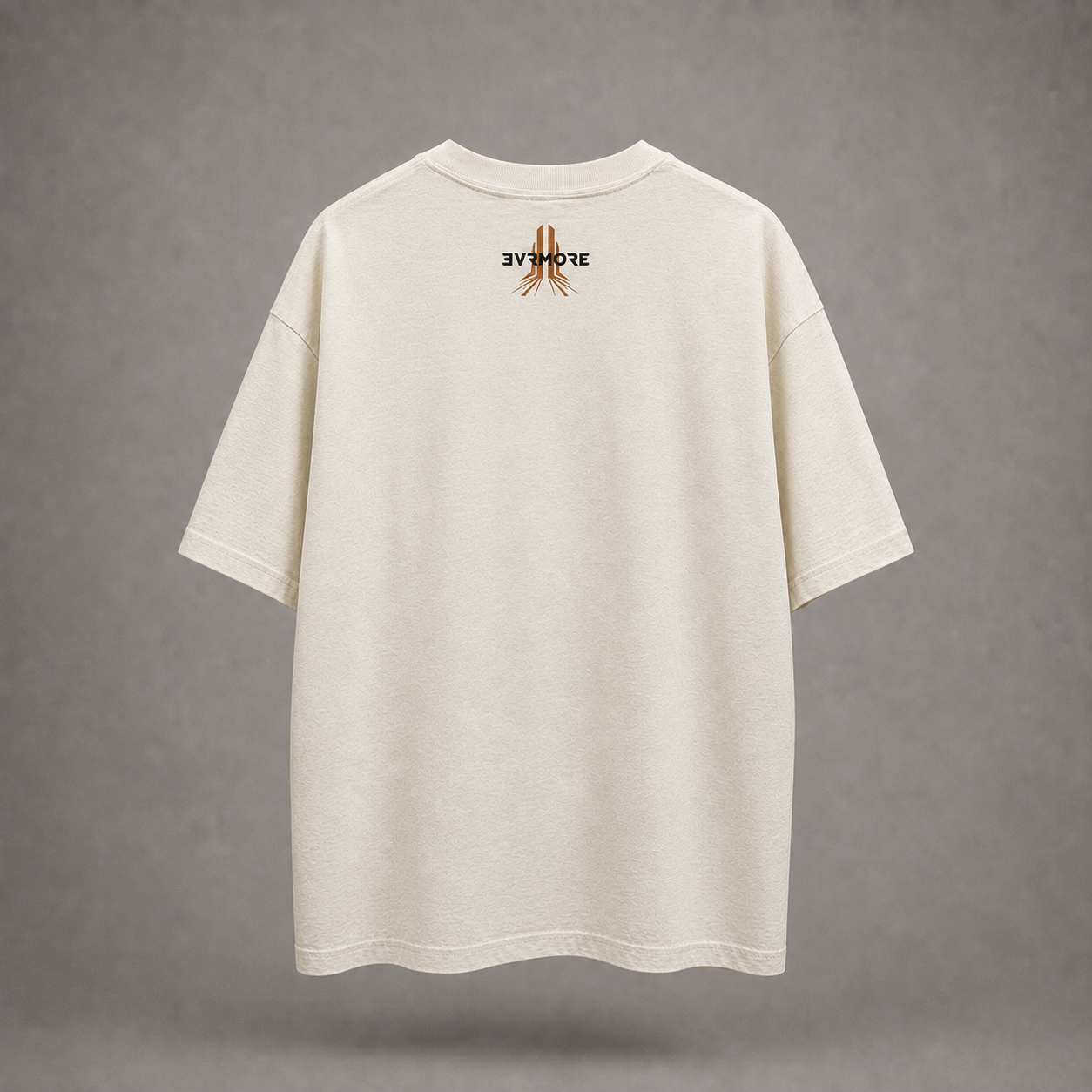 An oversized off-white t-shirt shown from the back, featuring a small graphic print of praying hands with the text '3Y MOVE' in black and brown on the upper back, set against a neutral gray background.