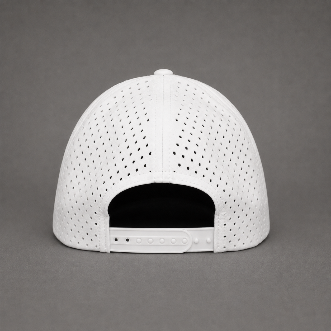White perforated snapback cap shown from the back on a neutral gray background.