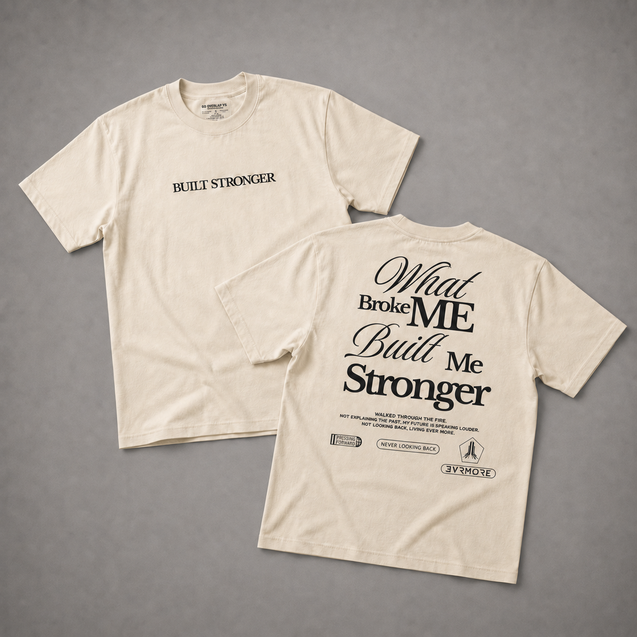 Two cream-colored t-shirts displayed on a neutral gray background, showing both the front and back designs. The front features the text 'BUILT STRONGER' in black on the left chest, while the back displays a large graphic with the text 'What Broke ME Built Me Stronger' in black.