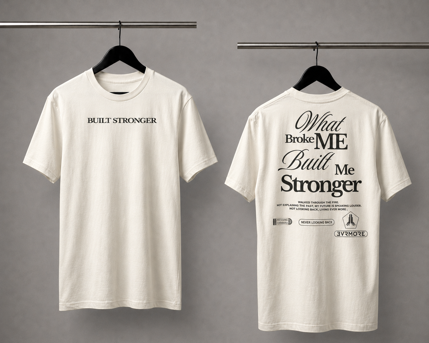 An off-white short-sleeve t-shirt shown from both front and back on black hangers against a gray background. The front features the text 'BUILT STRONGER' in black.