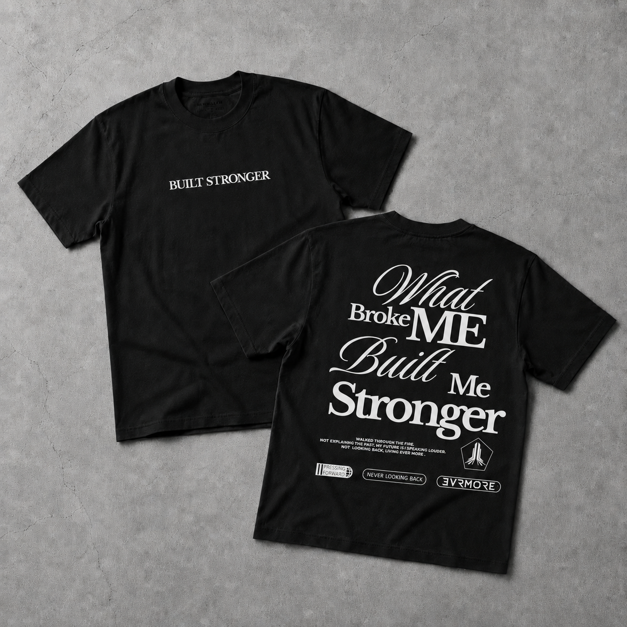 Two black short-sleeve T-shirts laid flat on a gray textured surface, showing the front and back designs. The front has small white text reading 'BUILT STRONGER' on the chest.