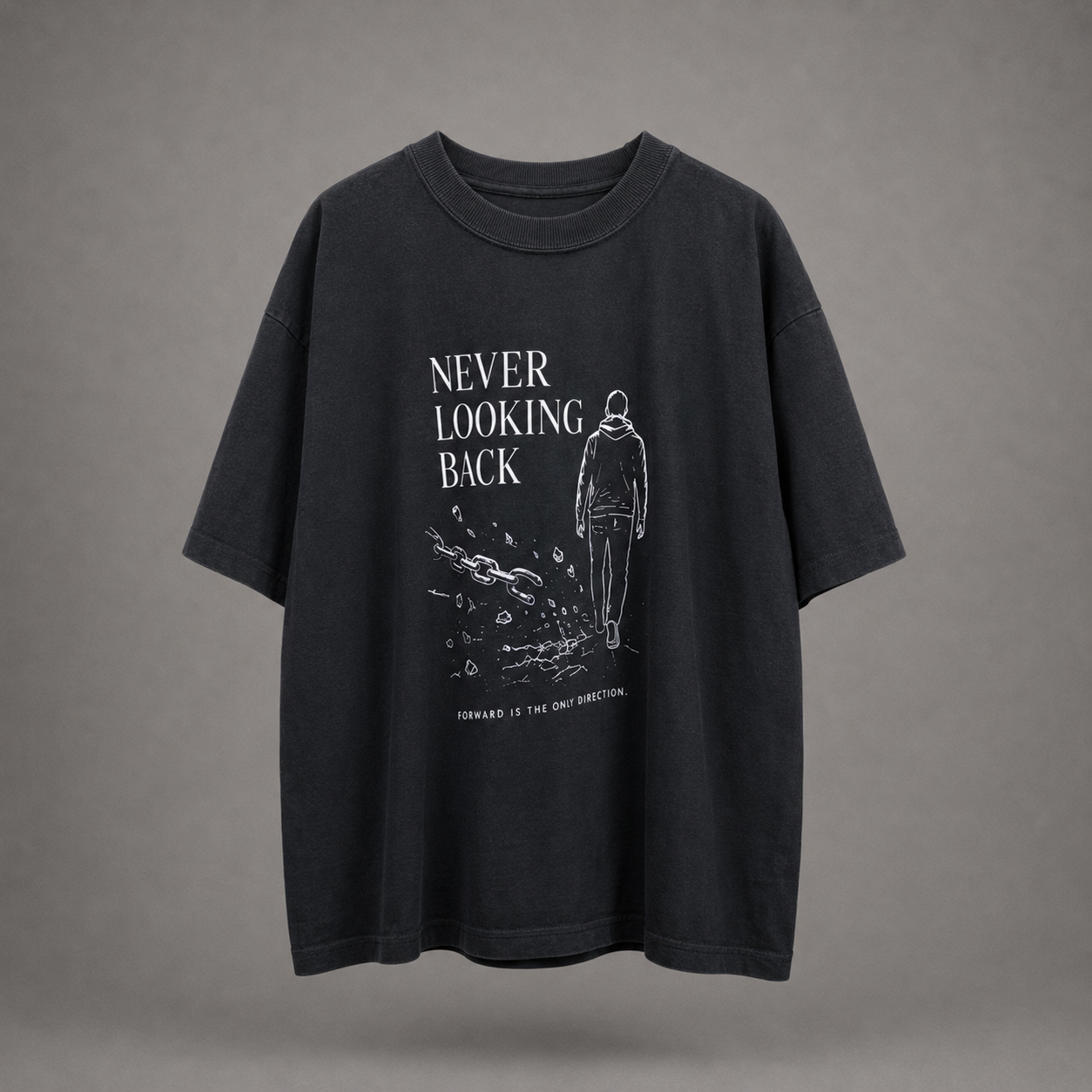 A dark charcoal gray oversized t-shirt with a white graphic print on the front featuring the text 'NEVER LOOKING BACK' and an illustration of a person walking away, shown against a neutral gray background.