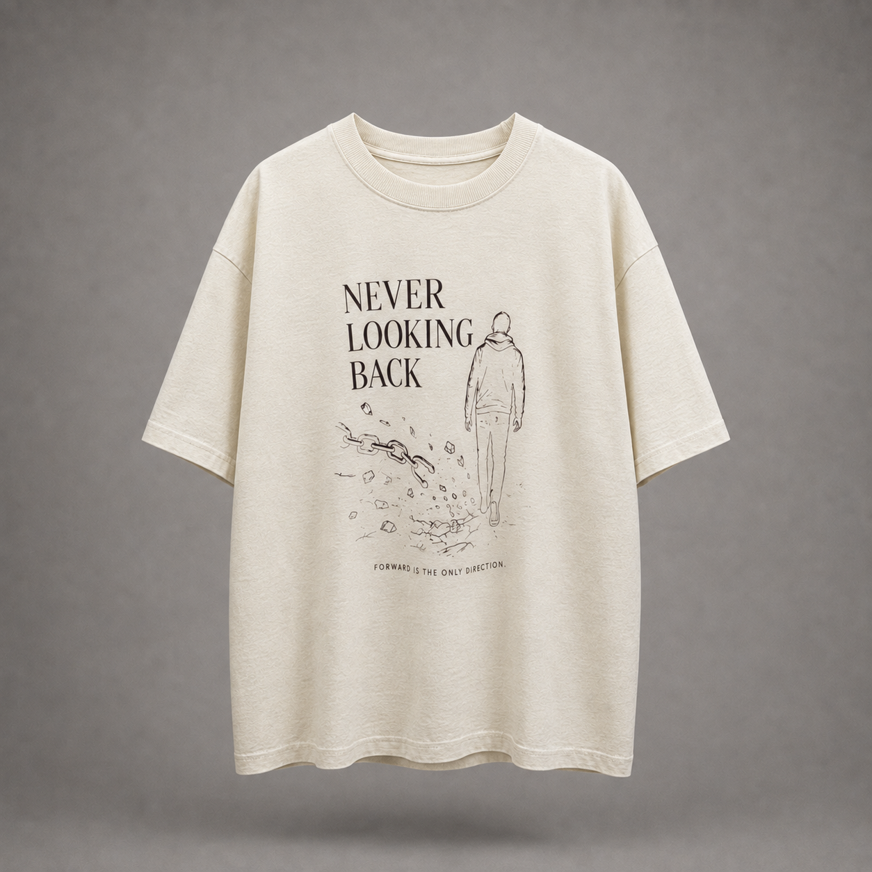An oversized cream-colored t-shirt with a black graphic print on the front featuring the text 'NEVER LOOKING BACK' and a minimalist line drawing of a person walking, set against a solid gray background.