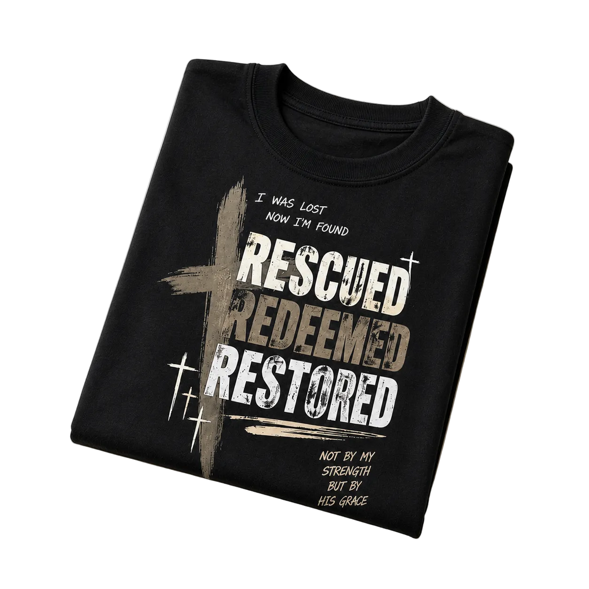 A folded black t-shirt with a distressed graphic print featuring a cross and the words 'RESCUED REDEEMED RESTORED' in white and beige, displayed on a light beige background.